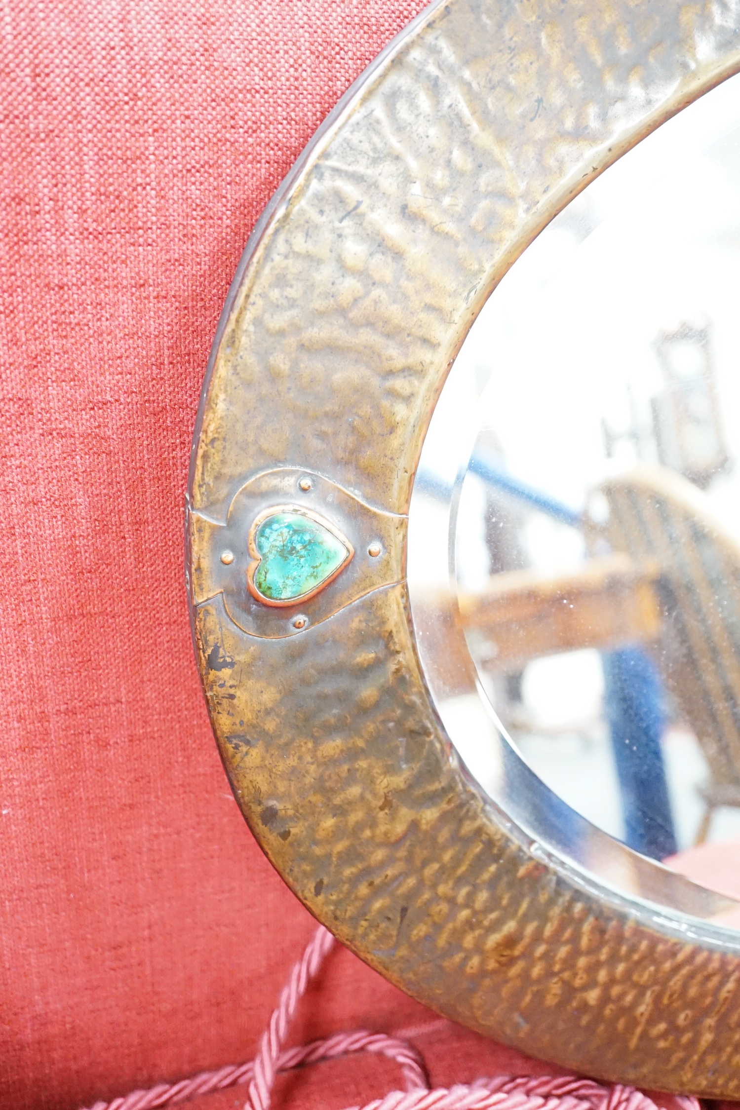 An Arts and Crafts style hammered copper mirror, width 86cm height 60cm